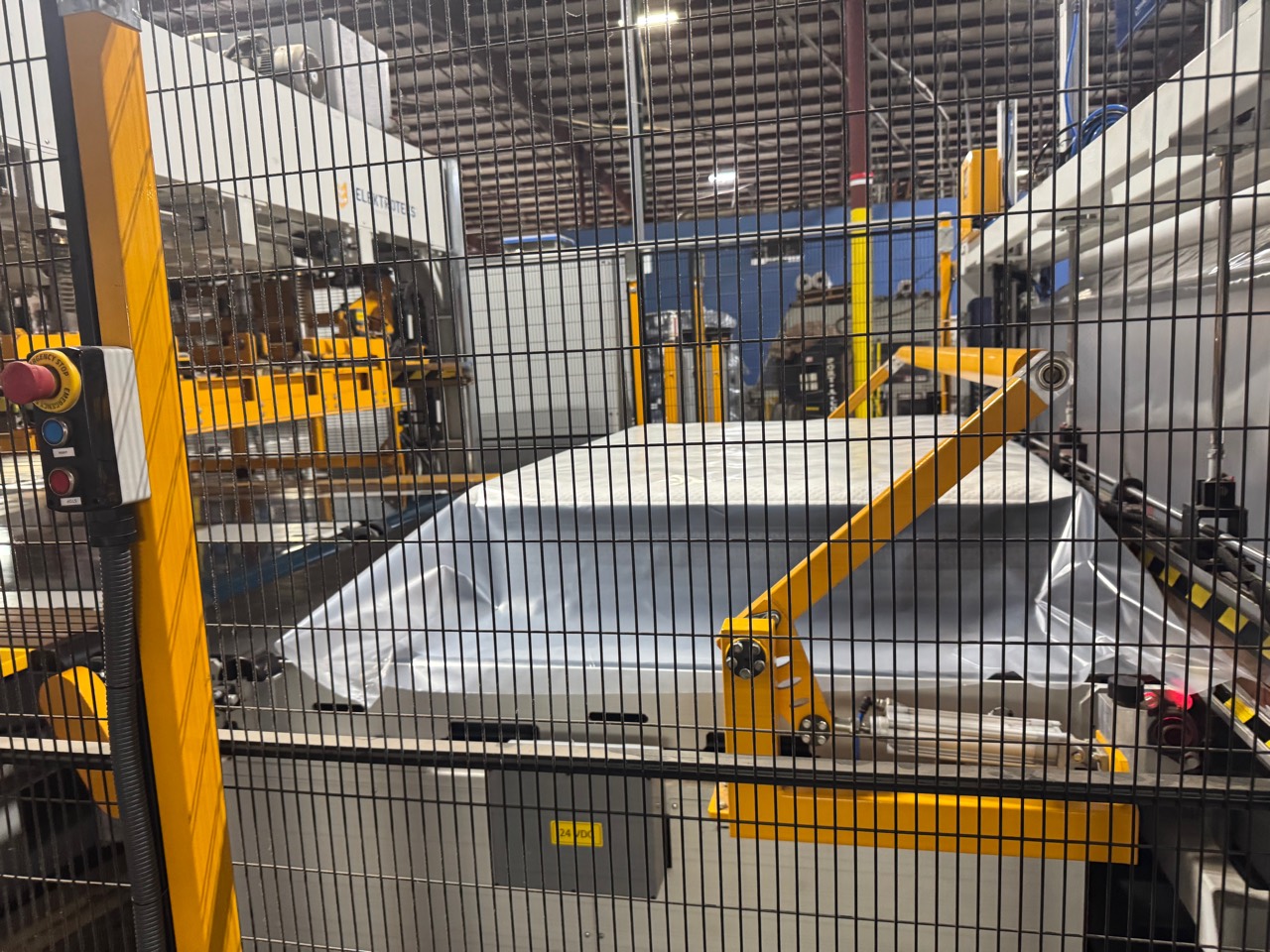 A finished unbranded mattress entering the compression line