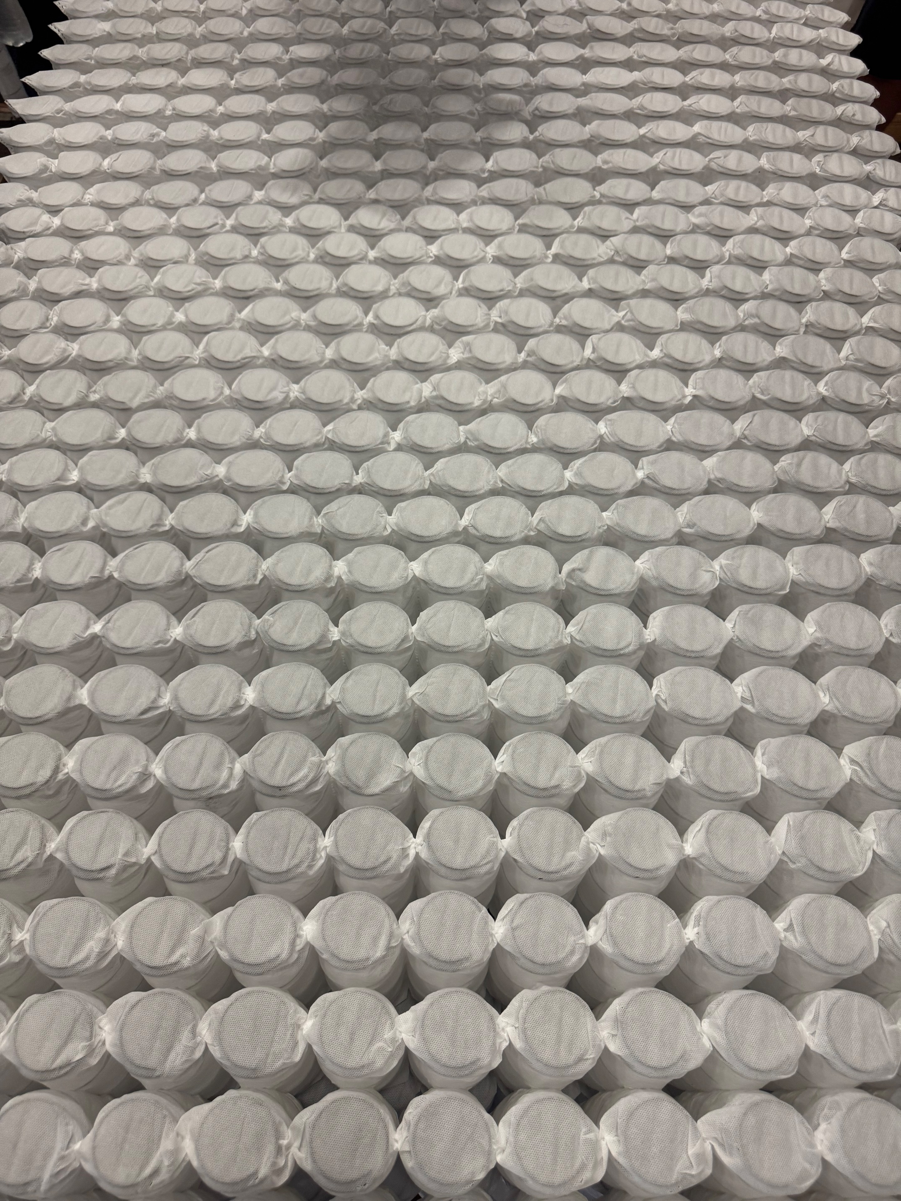 Rows of individually wrapped pocketed mattress coils