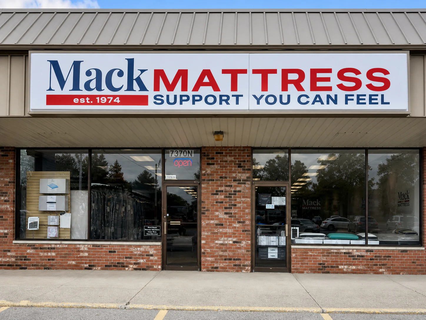 Exterior of Mack Mattress at 7370 Sawmill Road, showing the Mack Mattress sign and entrance