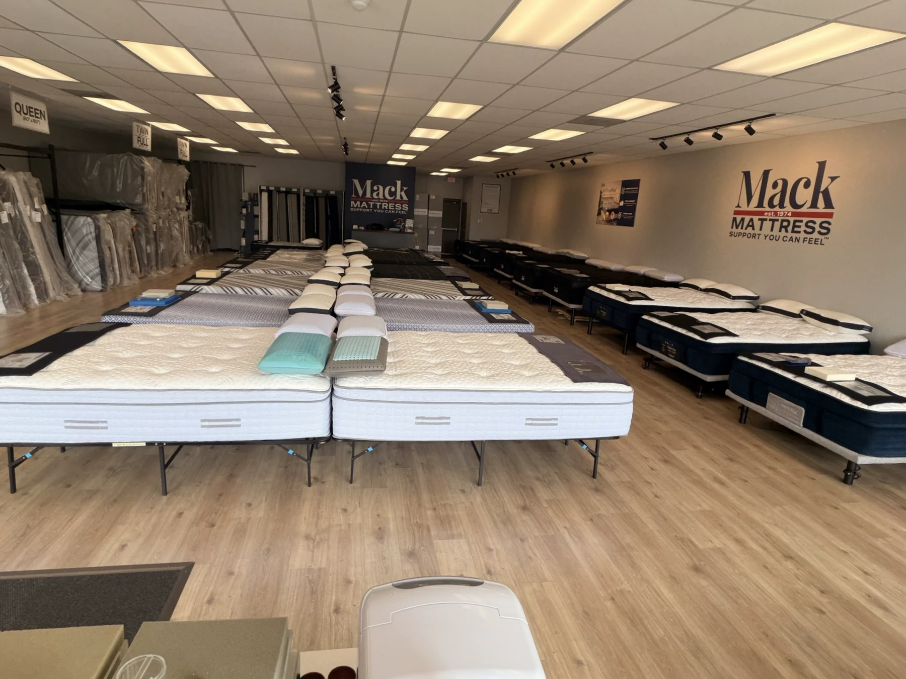 Mattress rows inside the real Mack Mattress showroom on Sawmill Road