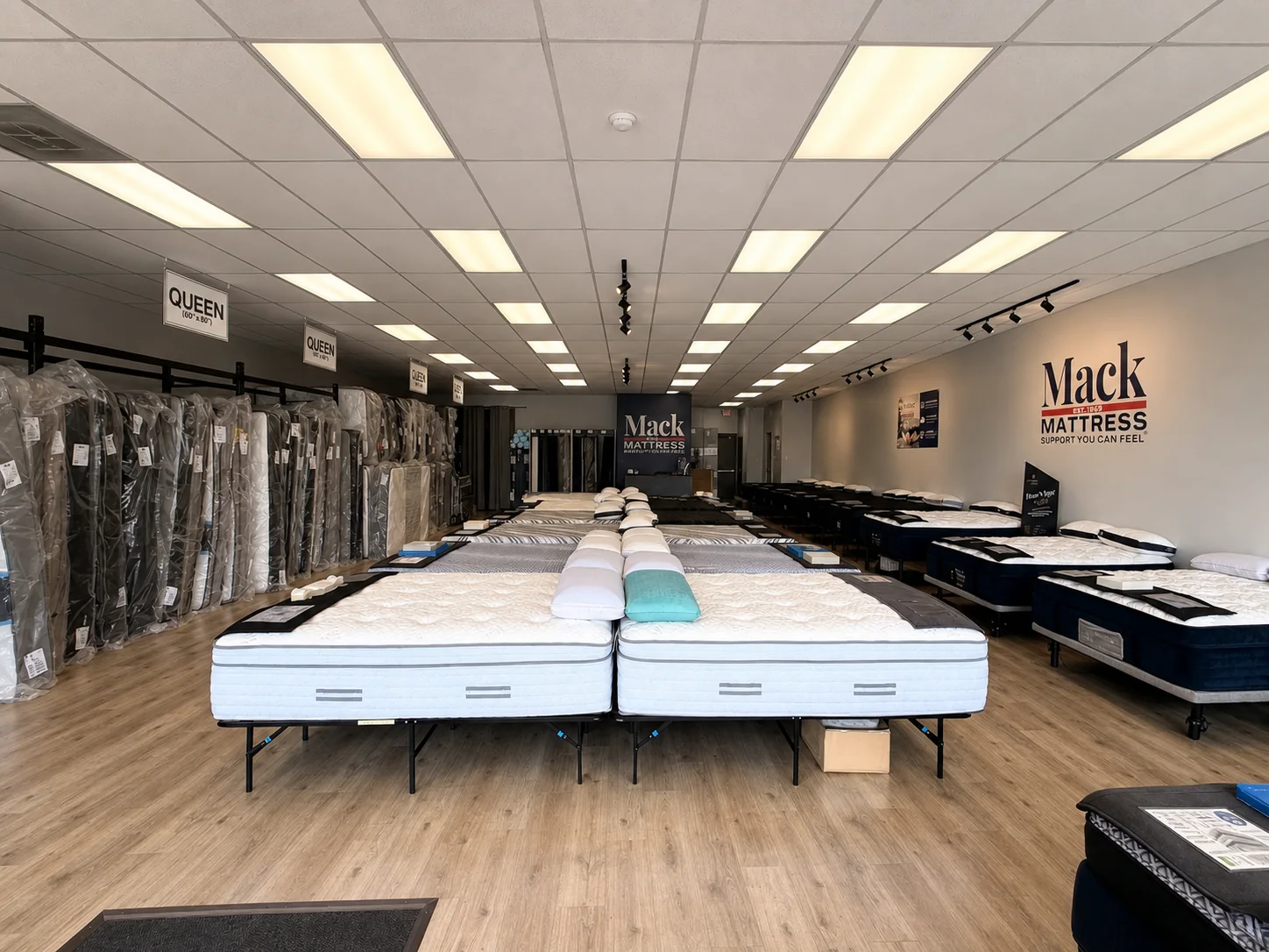 Mattresses arranged for side-by-side comparison in the Mack Mattress showroom